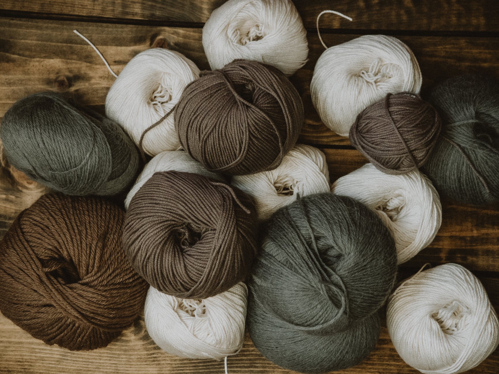 brown gray and white yarn rolls